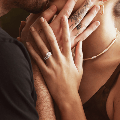 A couple where the woman wears a three carat lab grown diamond engagement ring