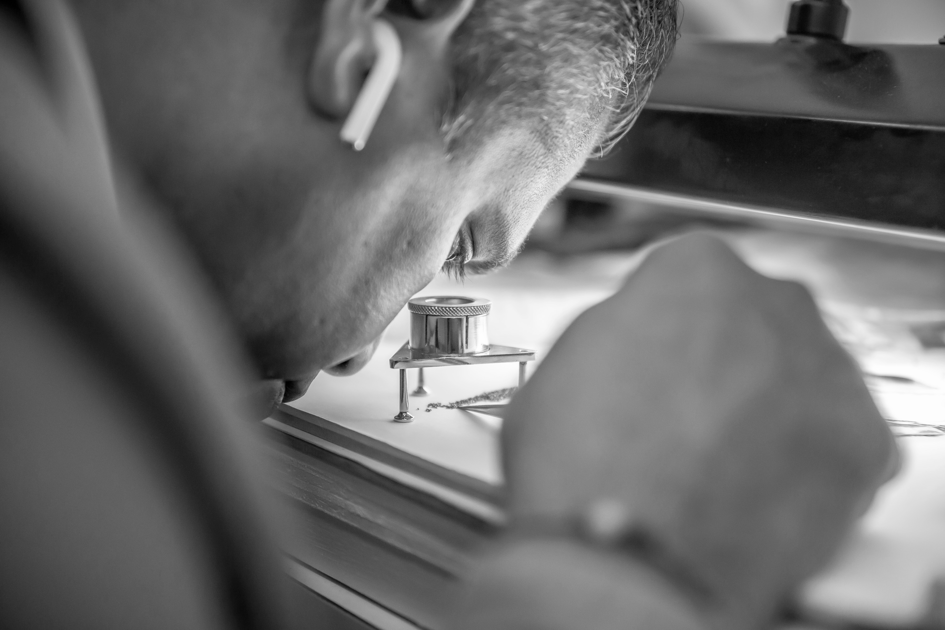 TACORI gemologist inspecting diamonds with a 10x loupe
