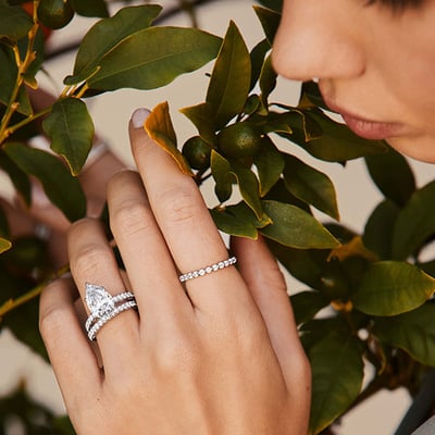 A model wears a platinum solitaire engagement ring 