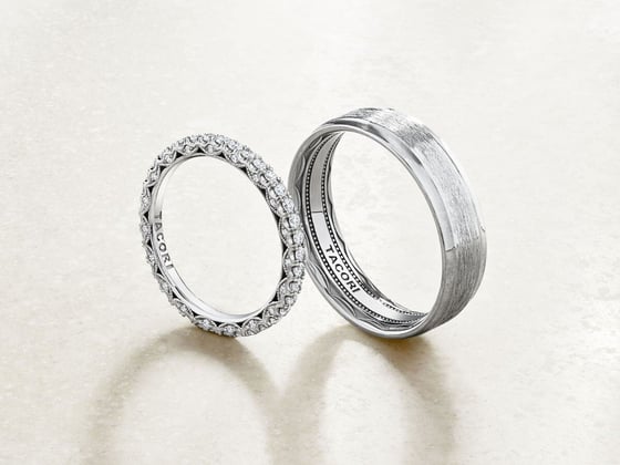 two white gold wedding bands, one with diamonds and one with a satin finish.